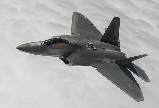 A F-22 Raptor fighter above the clouds