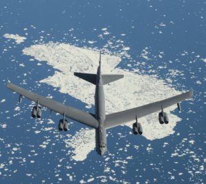 Picture of a B-52 Stratofortress bomber flying above water