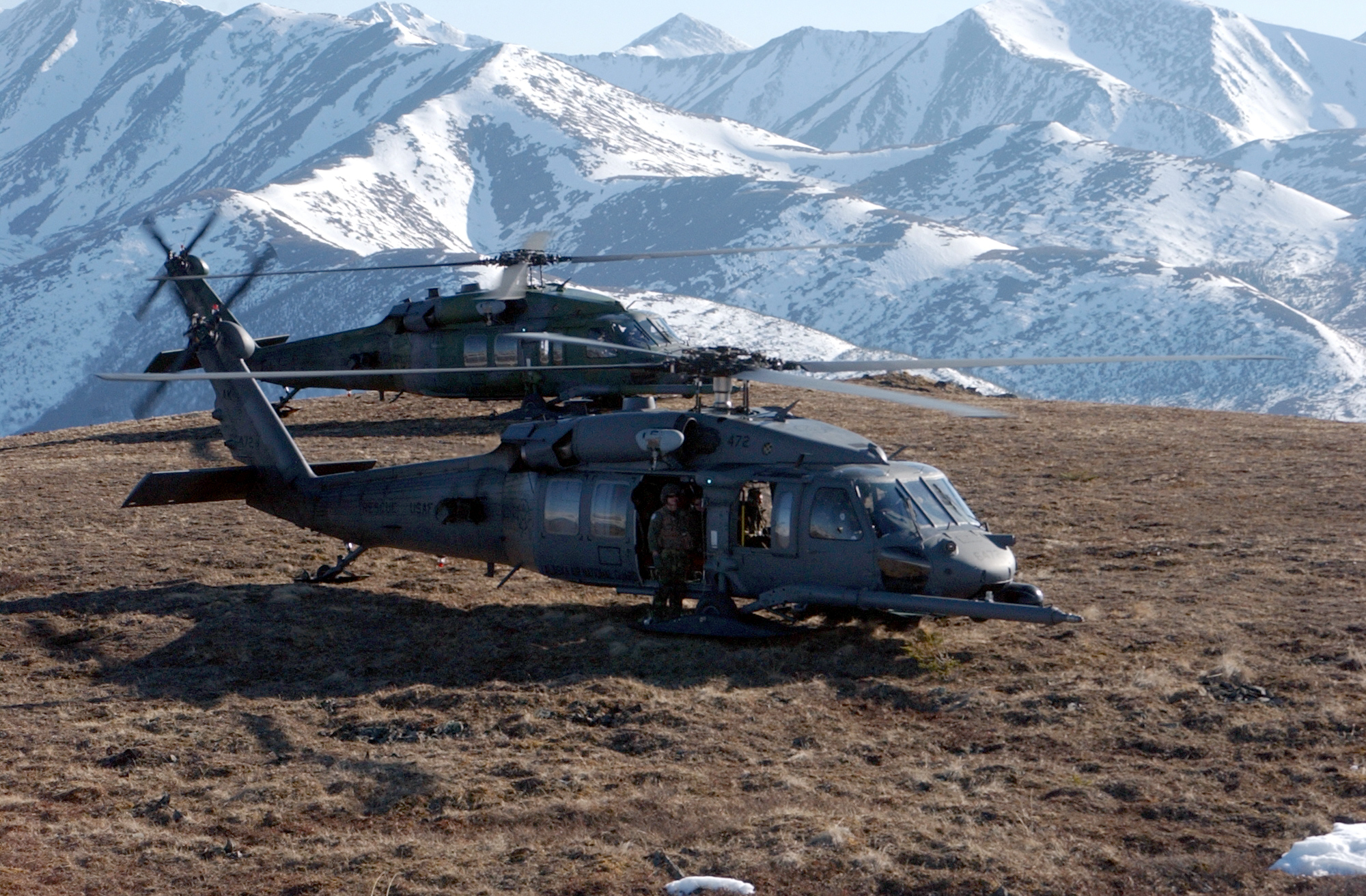 Two UH-60 Pave Hawk helicopters on a mountain