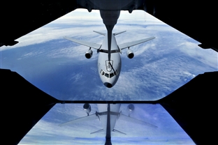 A KC-10 Extender refueling aircraft in the sky