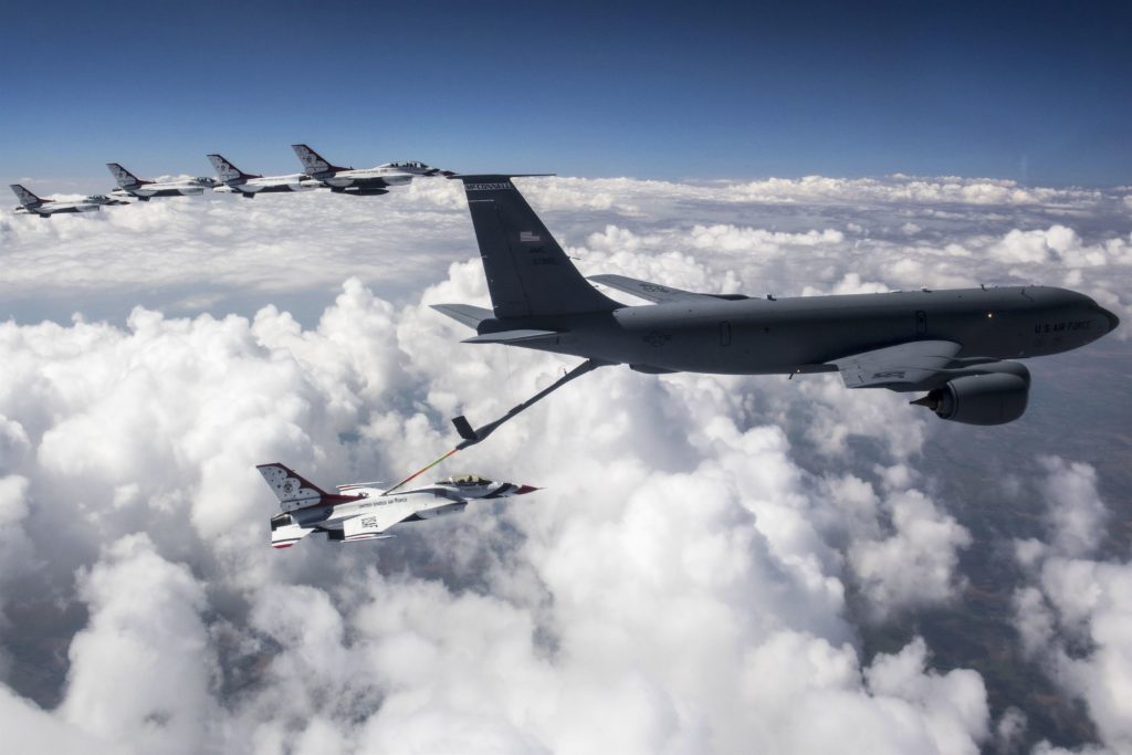 A KC-135 Stratotanker in the sky, refueling a fighter jet