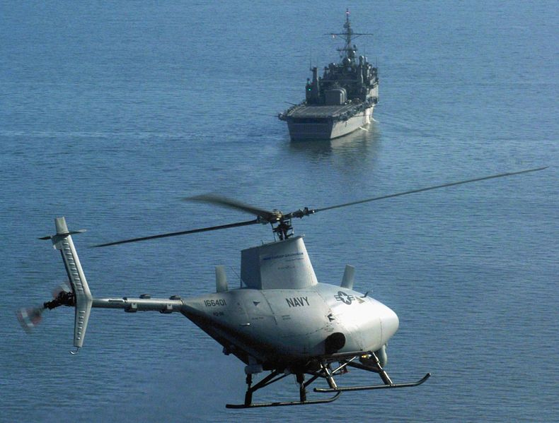 A MQ-8B Sea Fire Scout uncrewed helicopter circling a ship